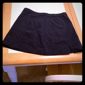 A navy blue and white stripped mini skirt